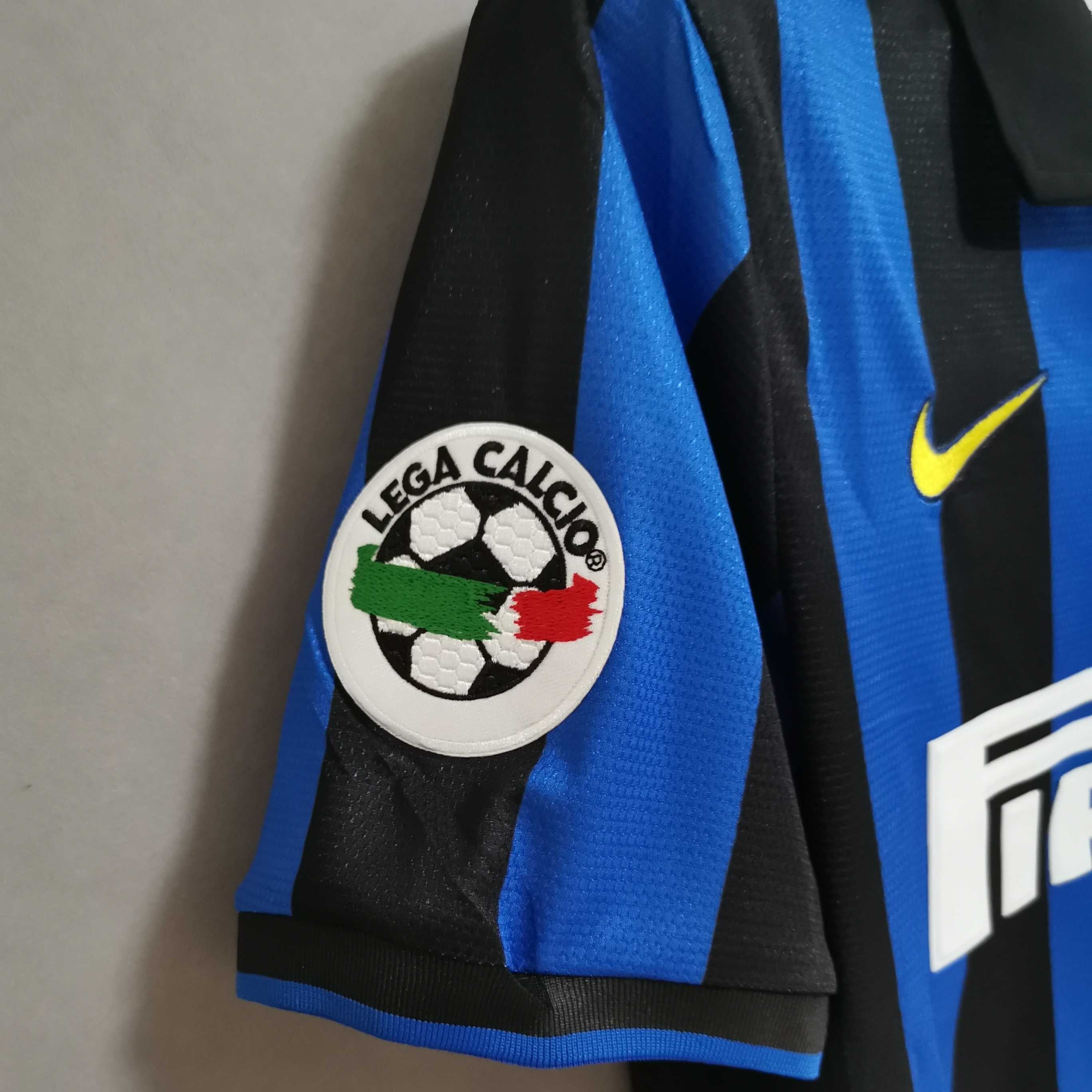 Dettaglio dello stemma dell'Inter con stella e trama del tessuto vintage 1998.