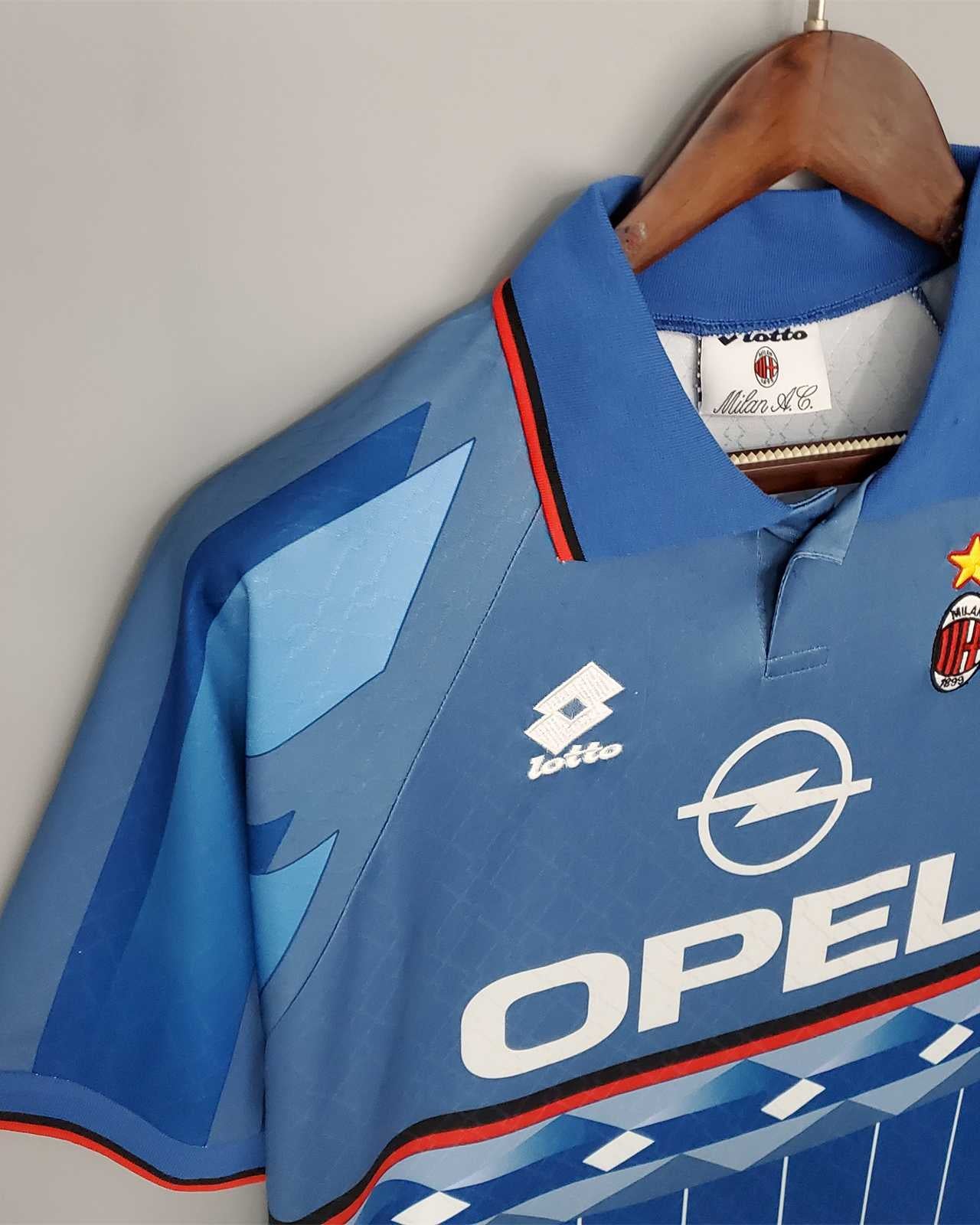 Dettaglio frontale kit vintage blu Milan 1995/96 con colletto a polo e trame verticali.
