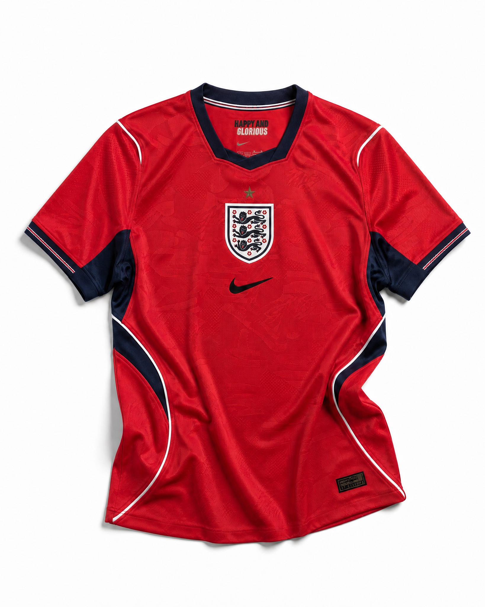 Fronte della maglia away dell'Inghilterra 2026 scura con dettagli geometrici colorati sui fianchi e stemma ricamato
