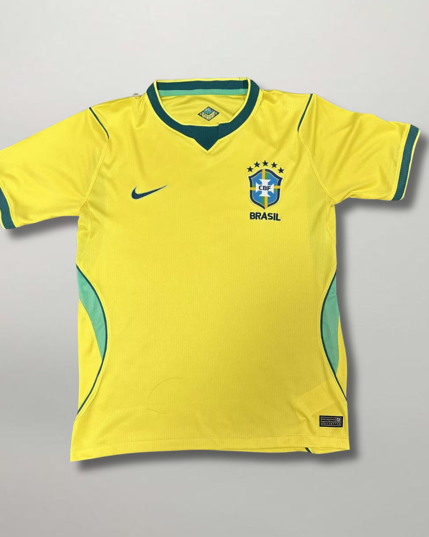 Fronte della maglia home del Brasile 2026 giallo oro con dettagli verdi e stemma stellato sul petto