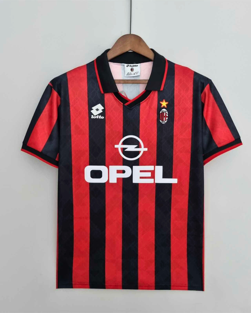 Fronte maglia rossonera Milan 1995/96 con strisce verticali e colletto a polo scuro.