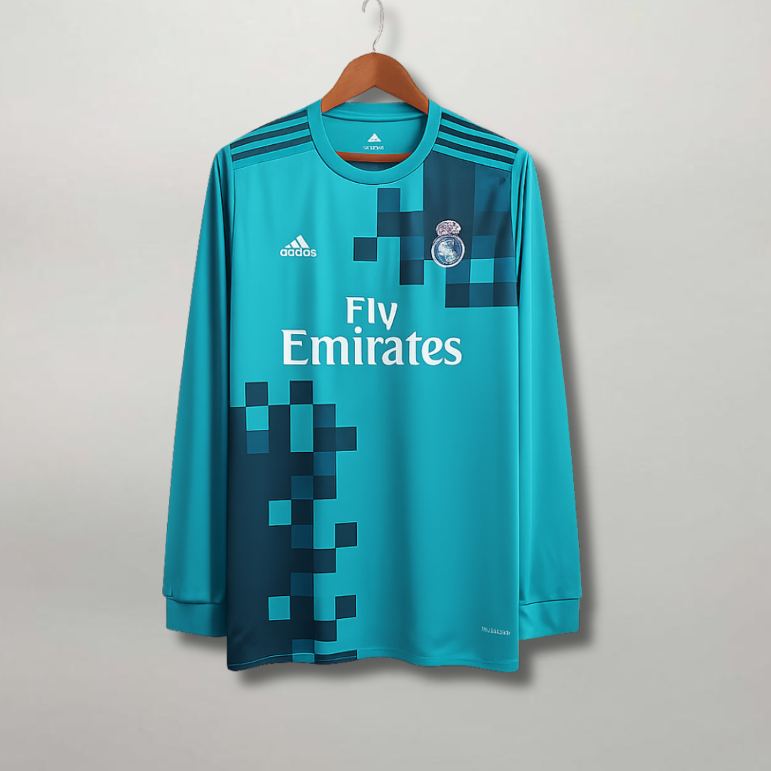 Maglia Real Madrid Third 2017/18 a maniche lunghe color turchese con grafica a pixel blu scuro.