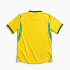 Vista posteriore della maglia gialla della nazionale brasiliana 2026 con rifiniture laterali verdi
