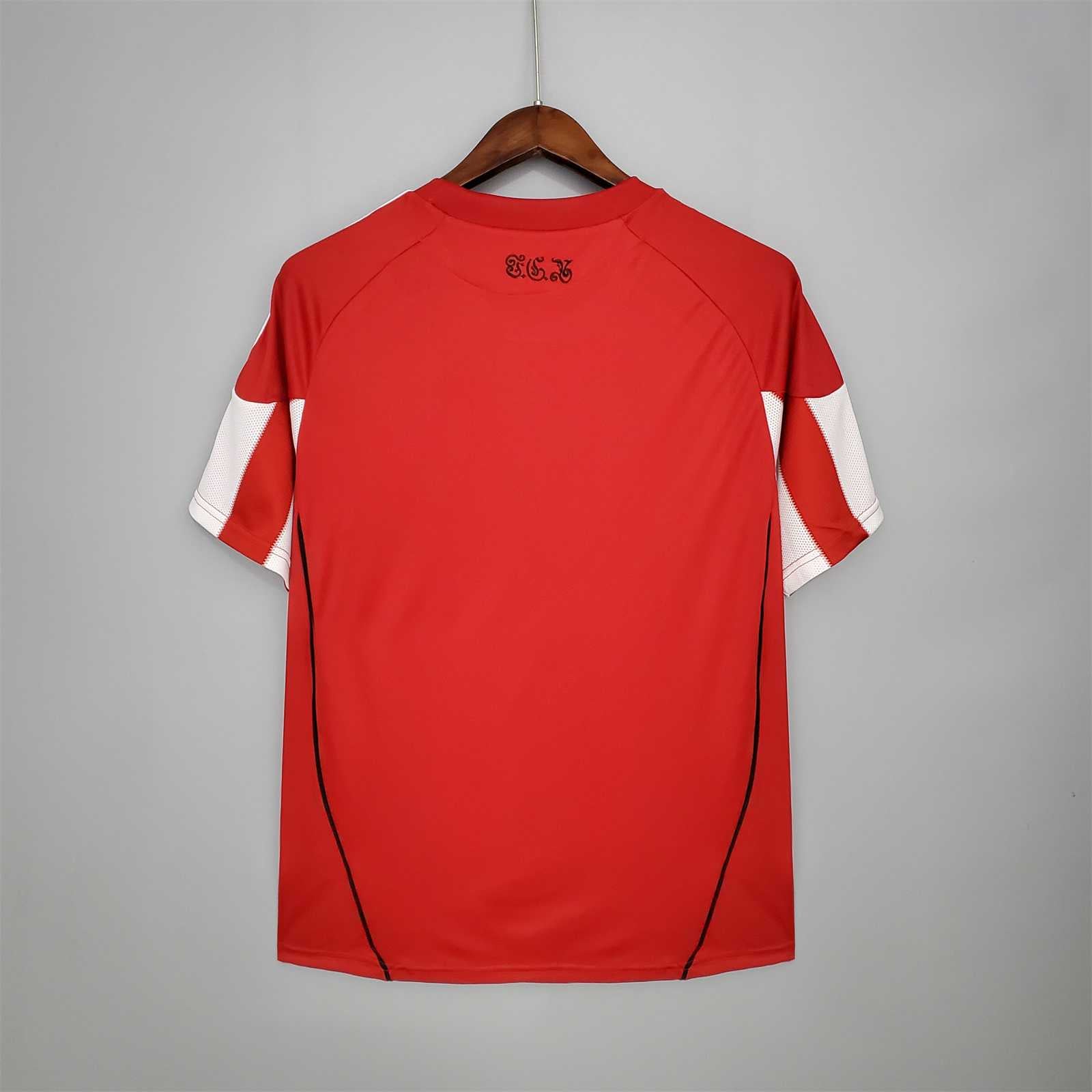 Retro della maglia Bayern Monaco 2010/11 rossa con dettagli bianchi e bordo inferiore rifinito.